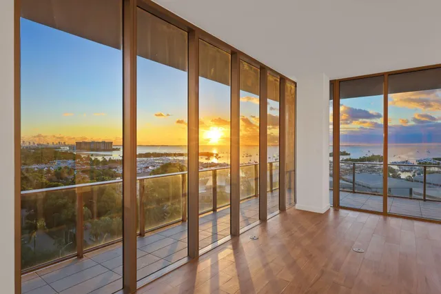 a kitchen with granite countertop a refrigerator and cabinets