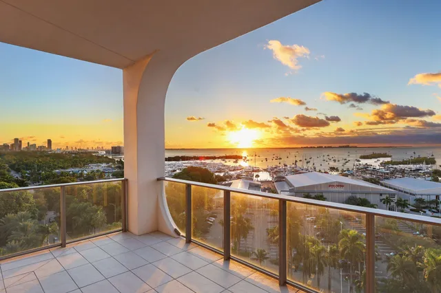 a bedroom with a bed and a large window with the garden view