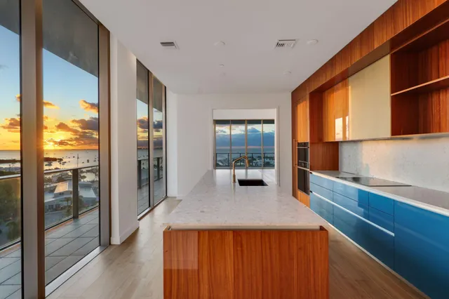 a walk in closet with wooden floor