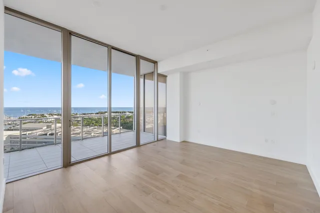 a view of a hallway with wooden floor and a window