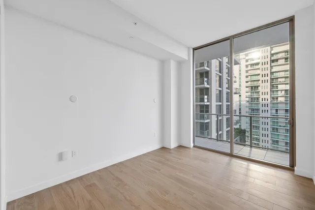 a living room with furniture a chandelier and a large window