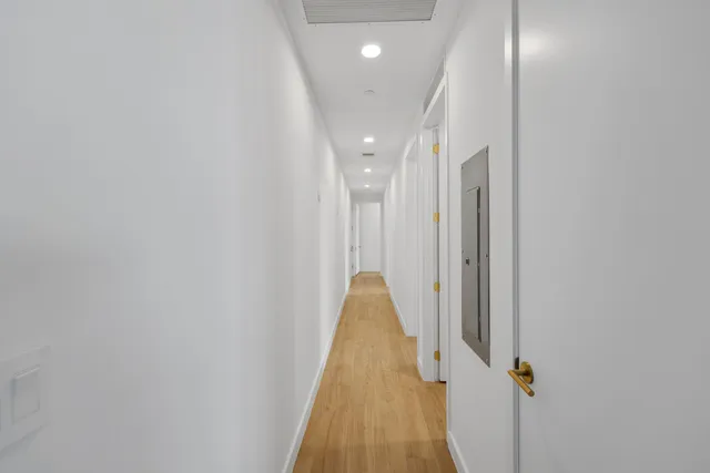 a view of a patio with dining table and chairs under an umbrella