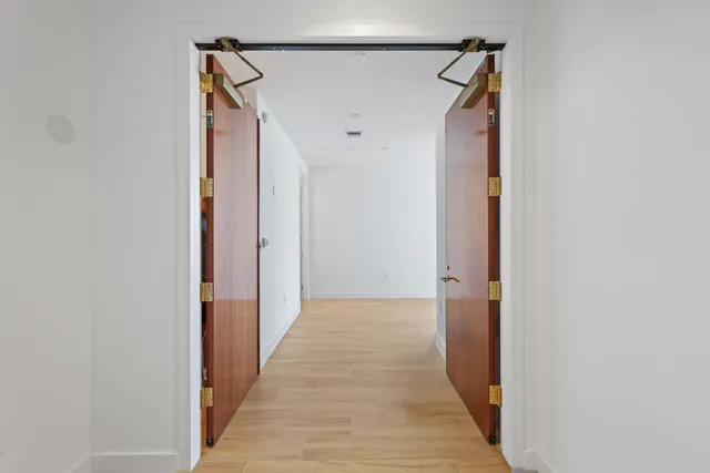 wooden floor in an empty room with large windows