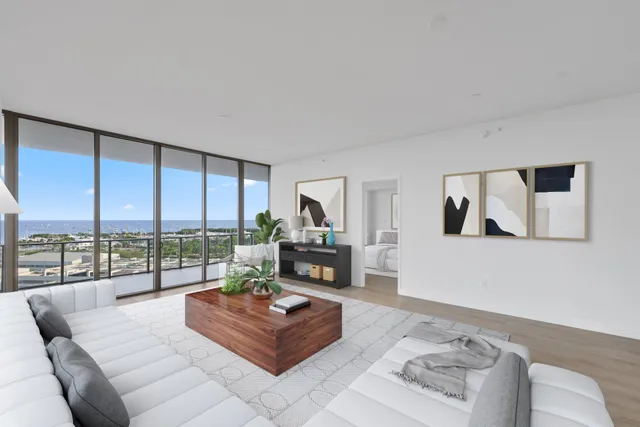 a view of an empty room with wooden floor and a floor to ceiling window