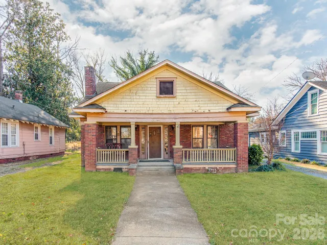 a view of a house with a yard and garden