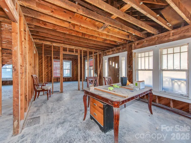 a room with pool table and windows
