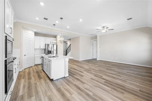 a view of a kitchen with furniture and wooden floor