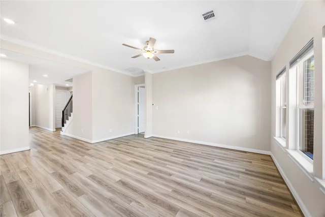 wooden floor in an empty room with a window