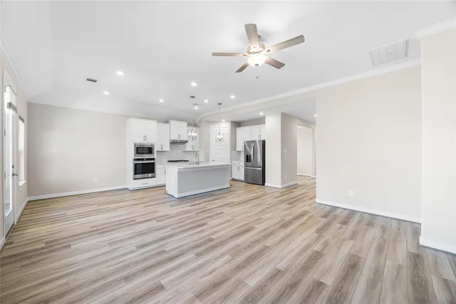 a view of a kitchen with a sink and a refrigerator