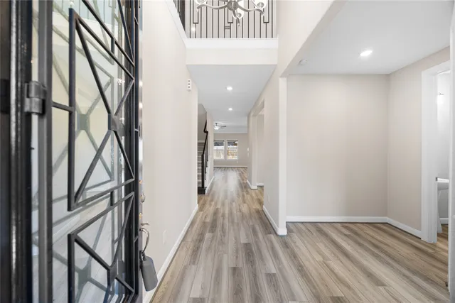 a view of hallway with wooden floor and staircase