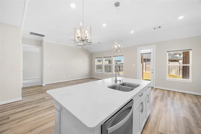 a kitchen with sink and wooden floor