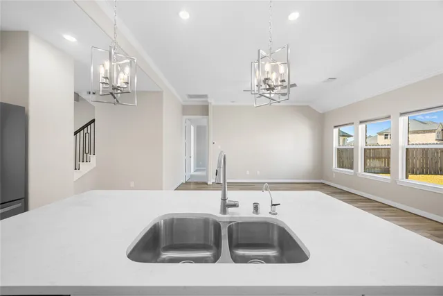 a kitchen with a sink and chandelier