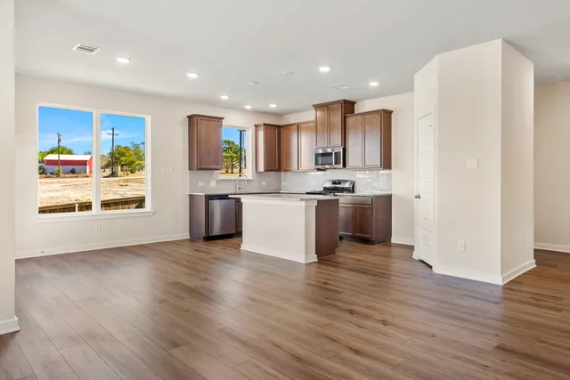 a view of kitchen with wooden floor and electronic appliances