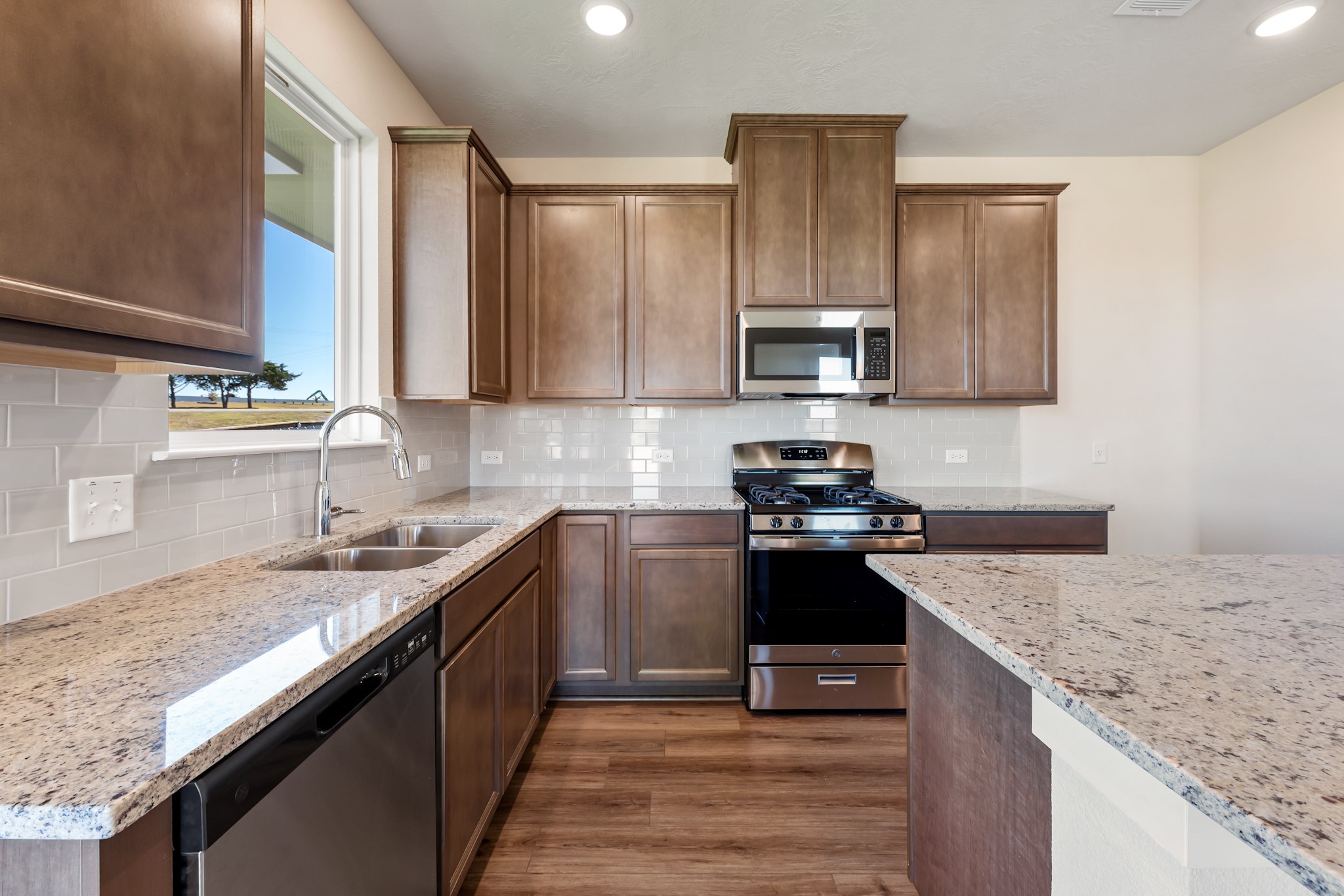1456 Lk Rdg Drive Brenham, TX 77833 - Photo 18 of 34 a kitchen with stainless steel appliances granite countertop a sink stove and refrigerator