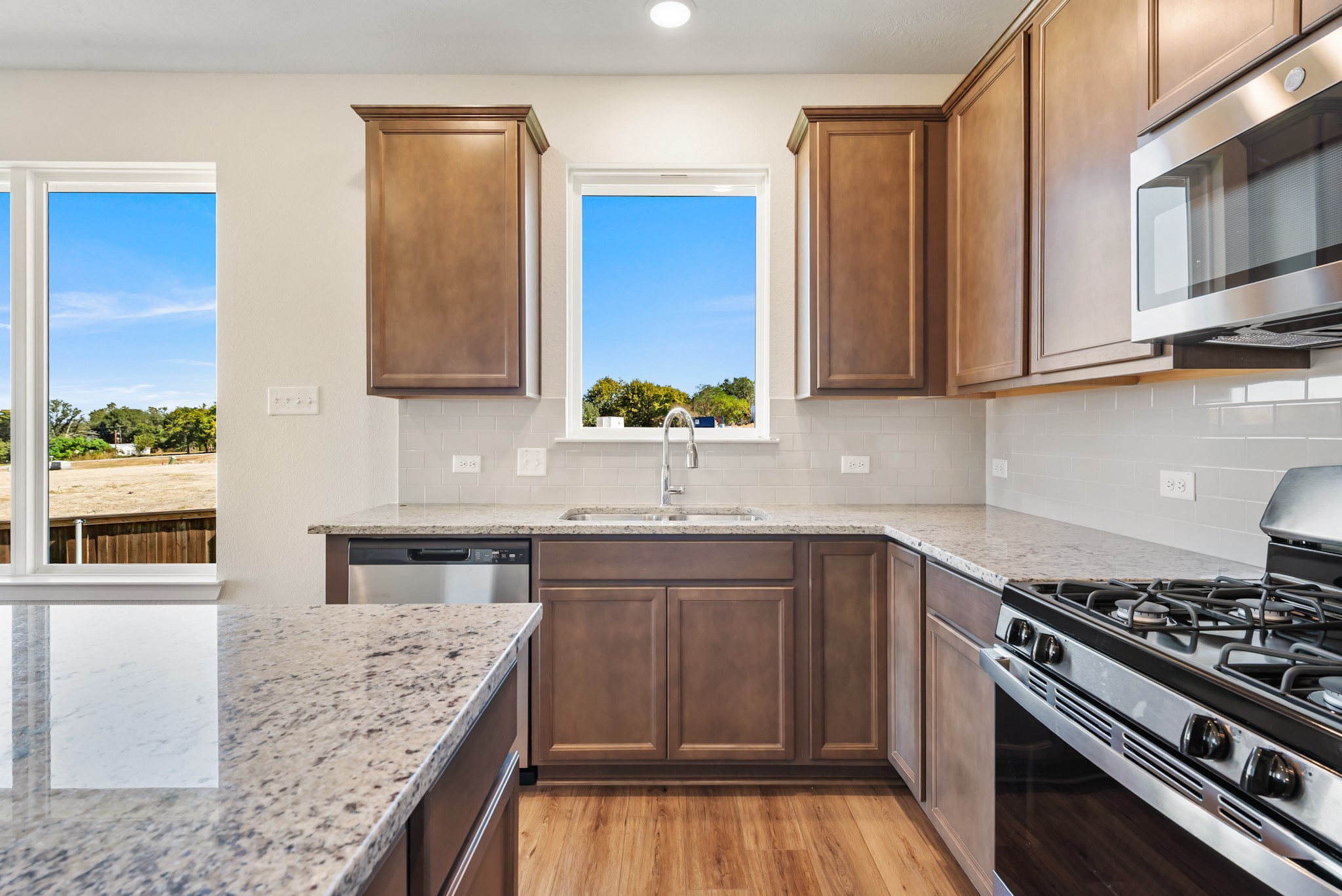 1456 Lk Rdg Drive Brenham, TX 77833 - Photo 20 of 34 a kitchen with stainless steel appliances granite countertop a stove a sink and a microwave