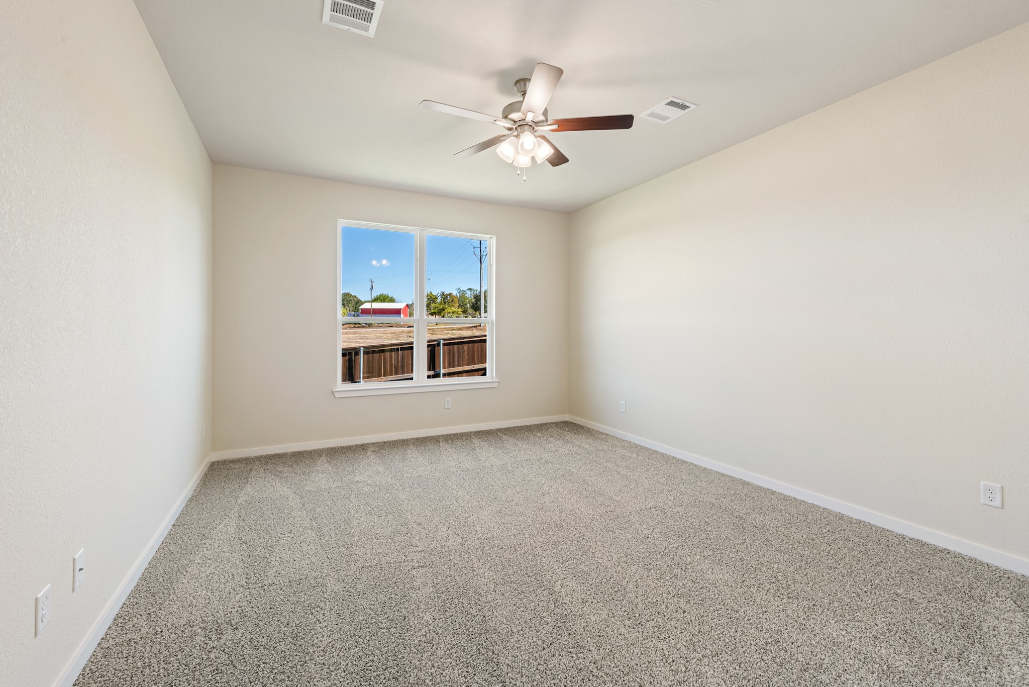 1456 Lk Rdg Drive Brenham, TX 77833 - Photo 23 of 34 an empty room with a ceiling fan and a window