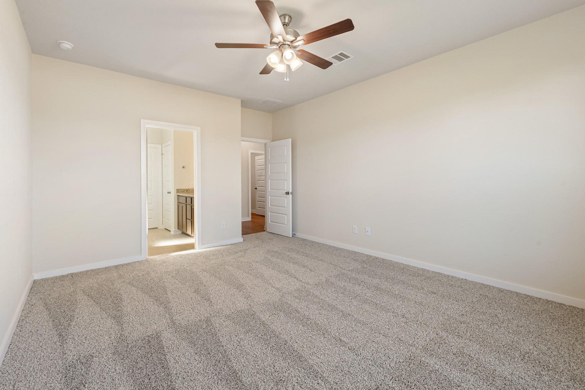 1456 Lk Rdg Drive Brenham, TX 77833 - Photo 26 of 34 an empty room with chandelier fan and windows