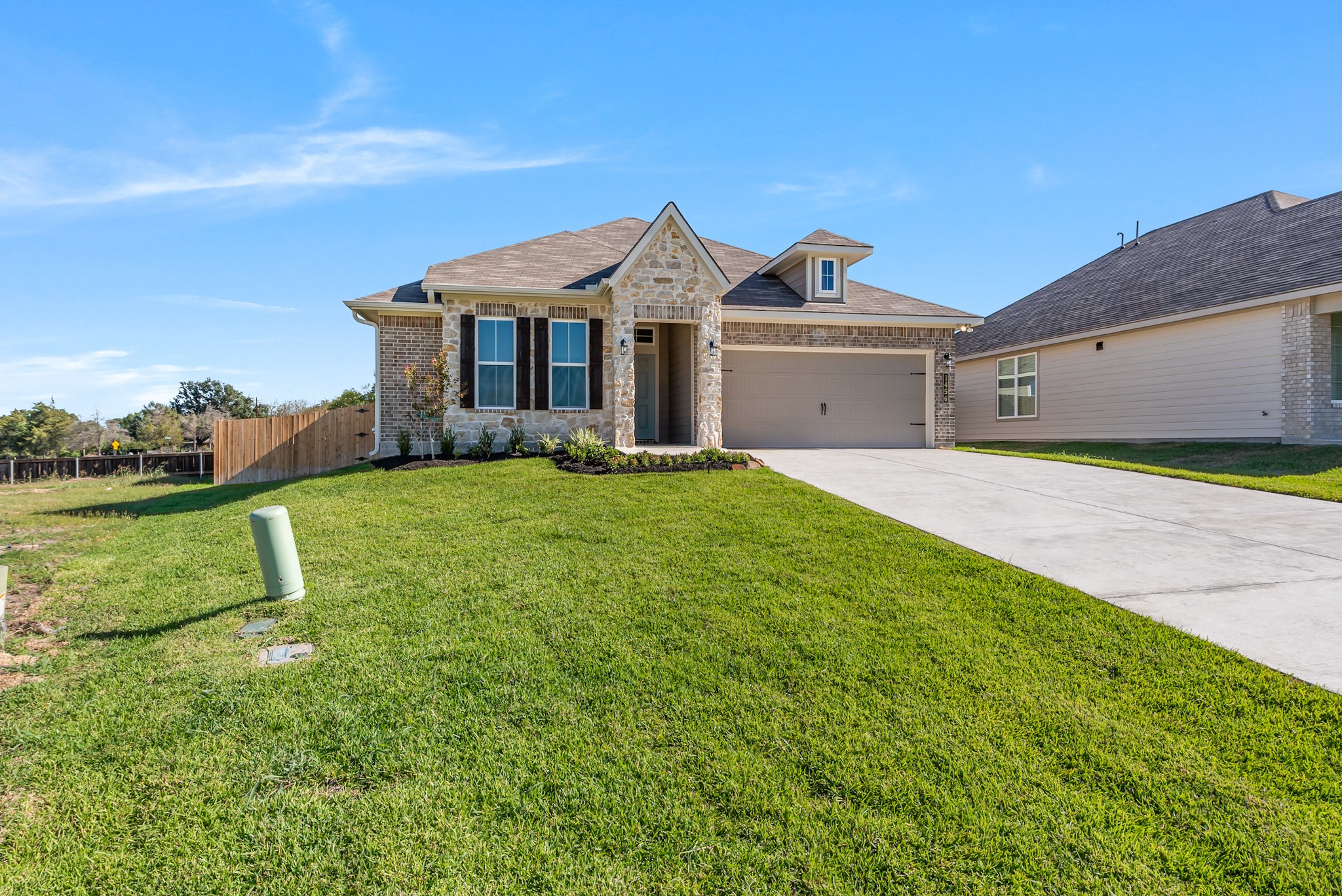 1456 Lk Rdg Drive Brenham, TX 77833 - Photo 3 of 34 a front view of a house with a yard and garage