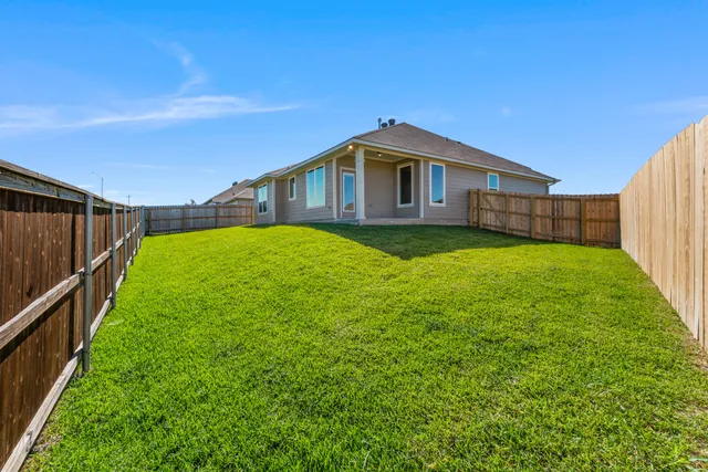 a yellow house with a yard