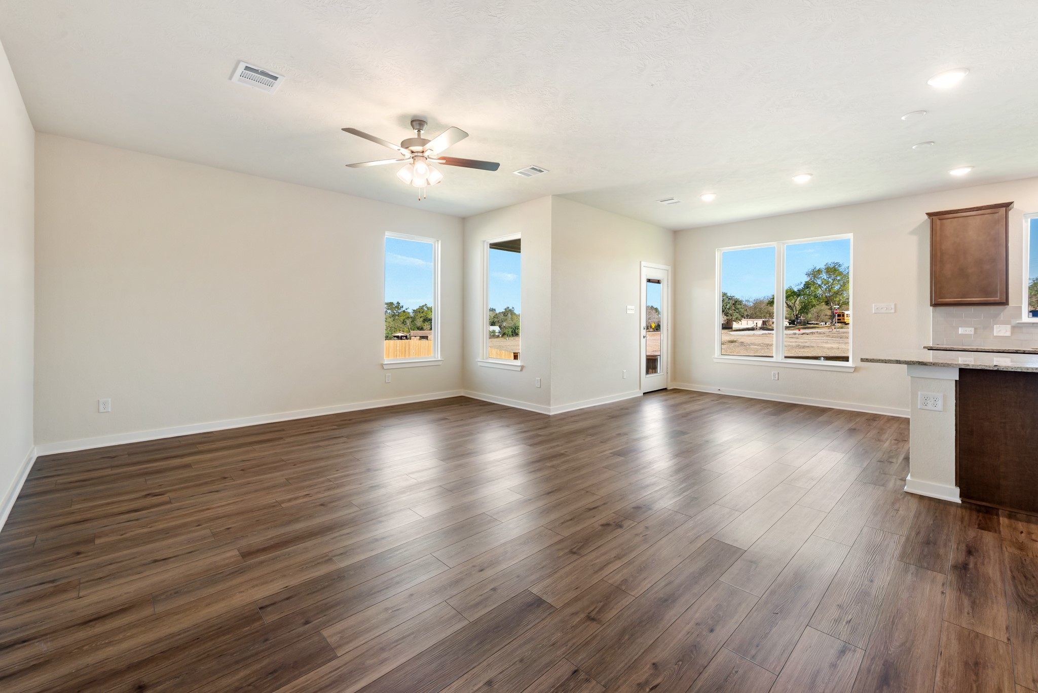 1456 Lk Rdg Drive Brenham, TX 77833 - Photo 9 of 34 a view of an empty room with wooden floor and a window