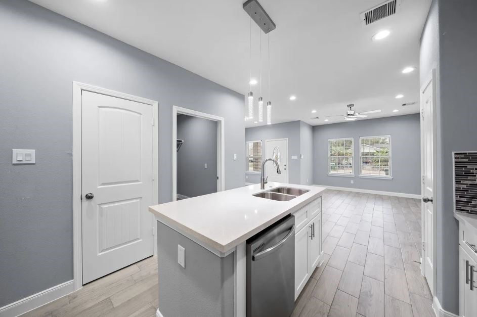5222 Bataan Road Houston, TX 77033 - Photo 5 of 22 Bright and modern kitchen showcasing clean lines, ample cabinetry, and luxurious functionality.