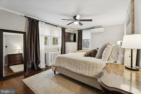 a bedroom with a large bed and a chandelier