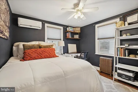 a bedroom with a bed a dresser and book shelf