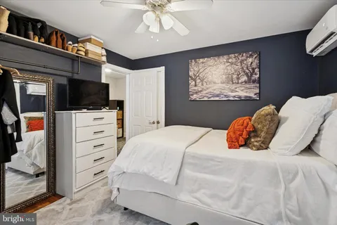 a bedroom with a bed closet and flat screen tv