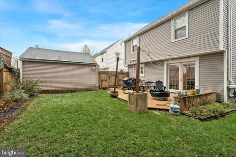 a view of backyard of house with outdoor seating and green space