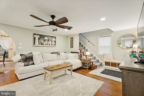 a living room with furniture and wooden floor