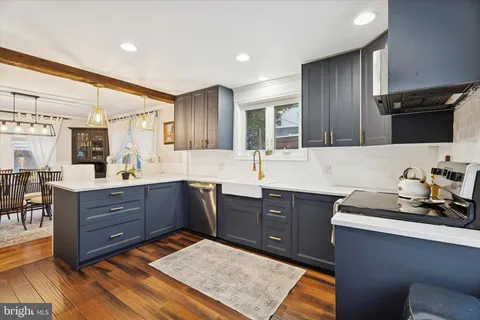 a kitchen with wooden cabinets and a stove top oven