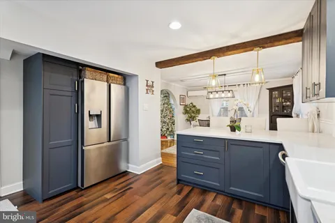 a kitchen with a refrigerator and a sink