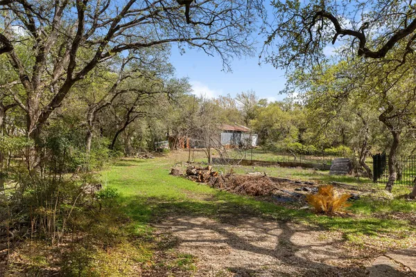 a view of backyard with large trees