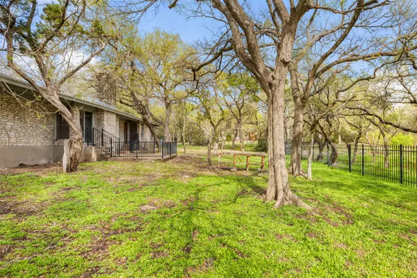a backyard of apartments with large trees