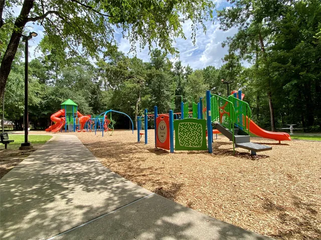 a view of a house with a backyard and a trees