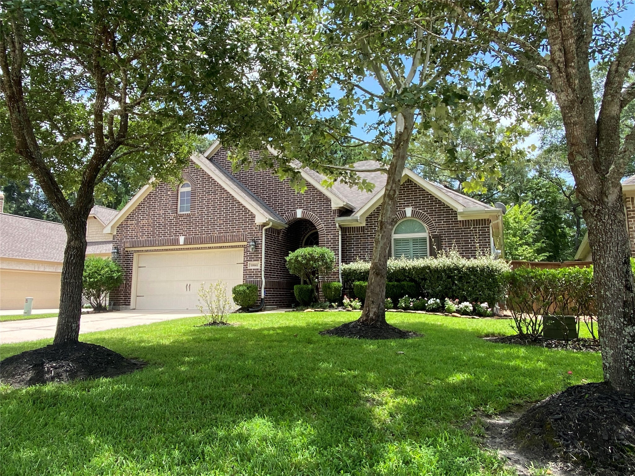 19861 Driver Forest Drive Porter, TX 77365 - Photo 4 of 38 a front view of a house with a yard and garage
