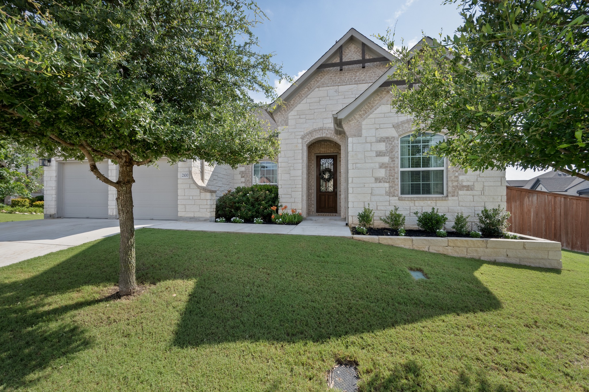 2100 Highland Ridge Road Georgetown, TX 78628 - Photo 3 of 30 A well-maintained lawn welcomes you to this attractive stone and brick-accented residence, complete with a two-car garage.