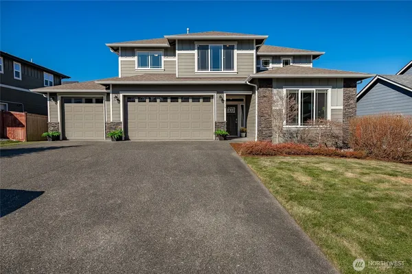 a front view of a house with a yard and garage