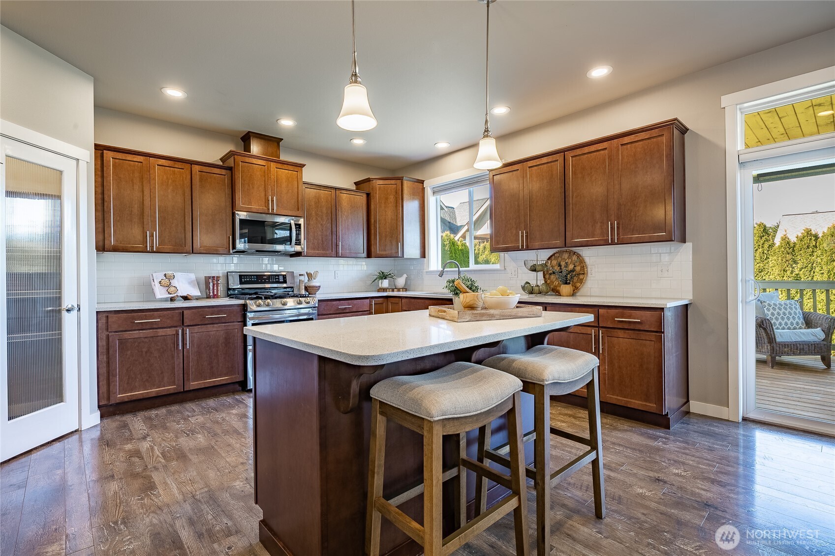 5319 Coastal Loop Blaine, WA 98230 - Photo 11 of 40 a kitchen with stainless steel appliances granite countertop a sink a stove a microwave a refrigerator cabinets and a dining table