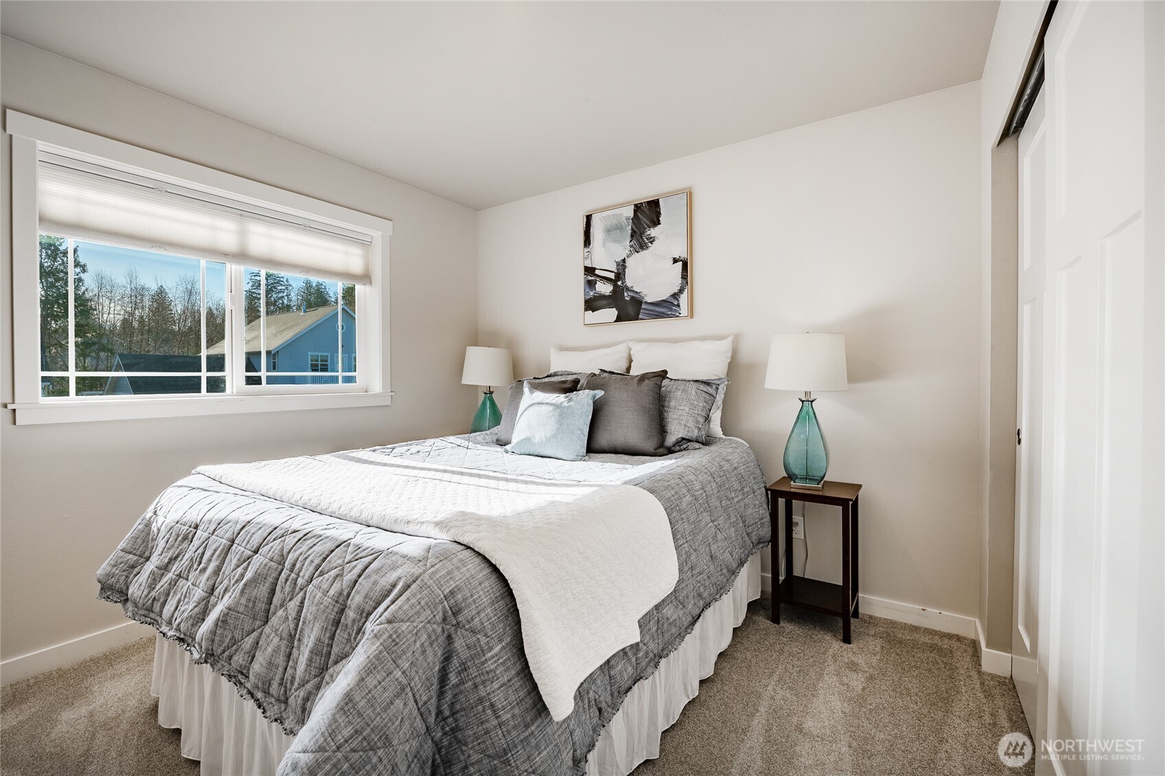 5319 Coastal Loop Blaine, WA 98230 - Photo 29 of 40 a bedroom with a bed and a large window