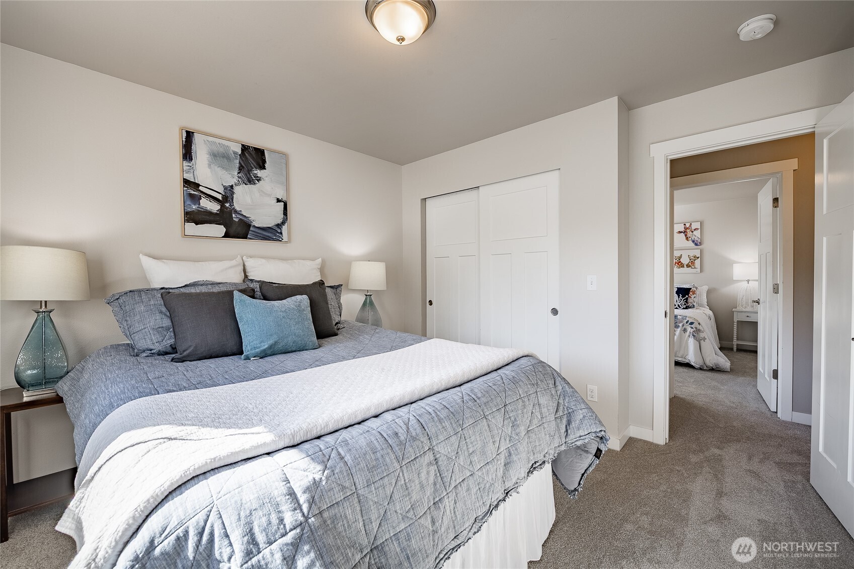 5319 Coastal Loop Blaine, WA 98230 - Photo 30 of 40 a bedroom with a bed and a lamp