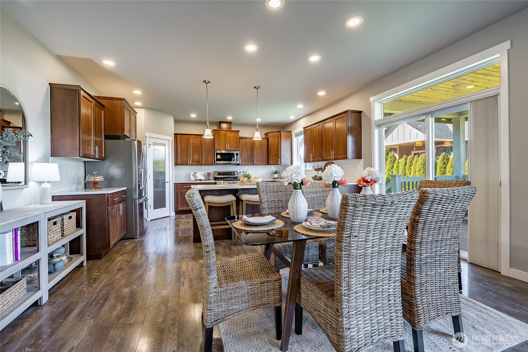 5319 Coastal Loop Blaine, WA 98230 - Photo 7 of 40 a kitchen with stainless steel appliances kitchen island granite countertop a refrigerator a stove top oven a sink dishwasher and white cabinets with wooden floor