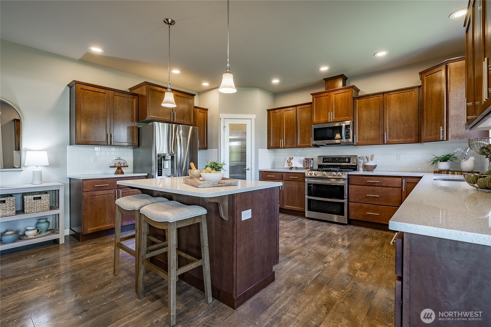 5319 Coastal Loop Blaine, WA 98230 - Photo 9 of 40 a kitchen with stainless steel appliances granite countertop a stove top oven a sink a stove a dining table and chairs