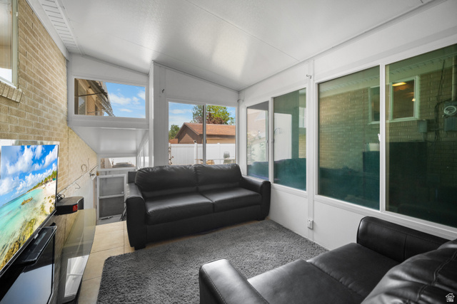 3233 Jean Street Magna, UT 84044 - Photo 12 of 33 Sunroom featuring a vaulted ceiling and an exposed brick wall