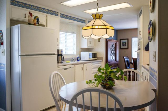 a dining room with furniture a livingroom and chandelier