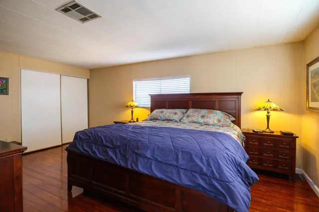 a bedroom with a bed and a flat screen tv