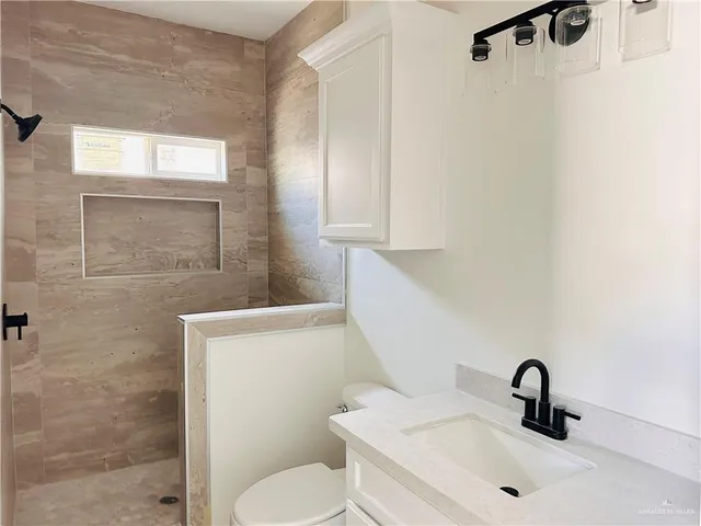 a bathroom with a sink toilet and shower