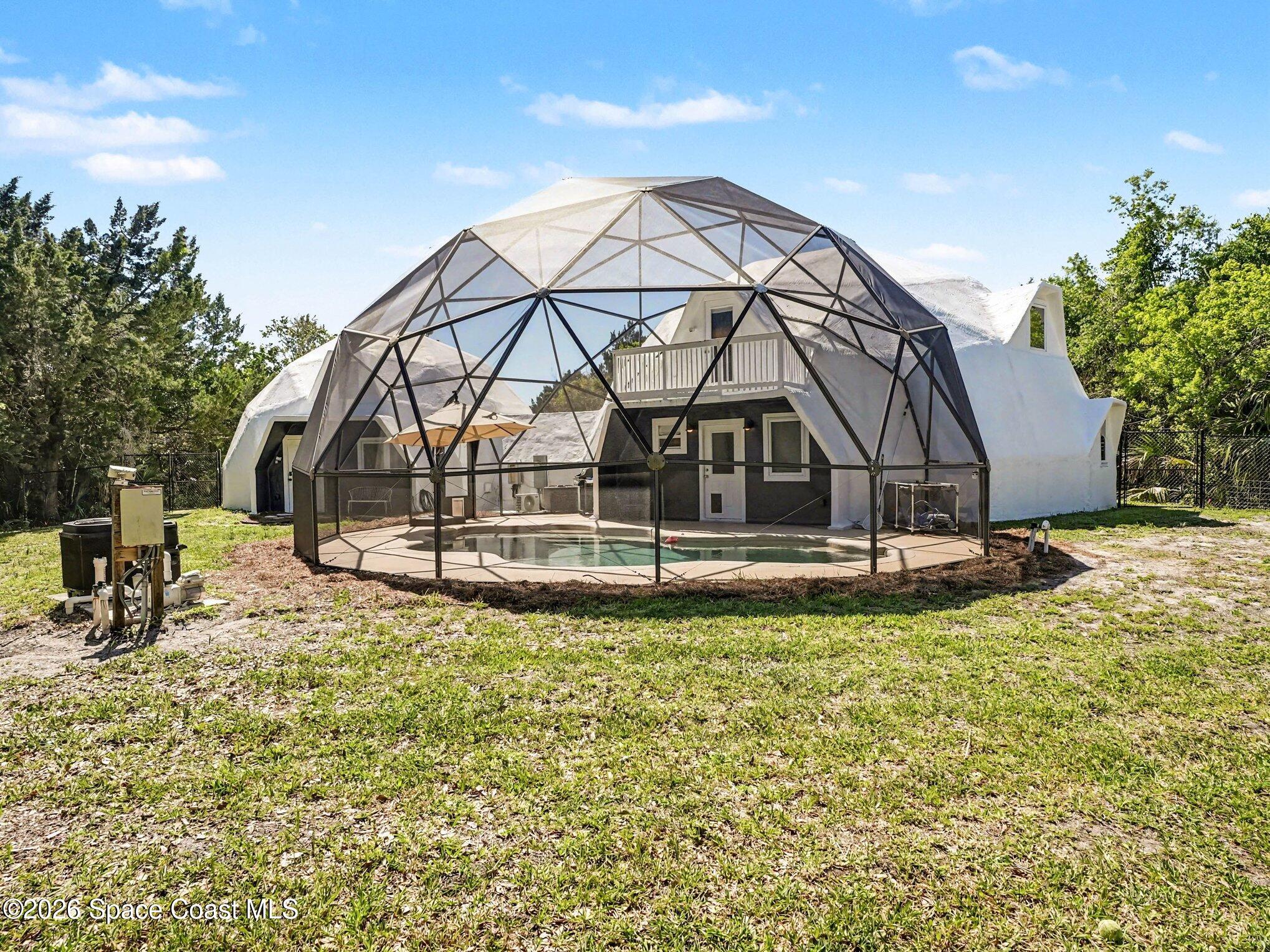 4045 Jake Avenue Cocoa, FL 32926 - Photo 32 of 35 a view of a house with swimming pool and sitting area