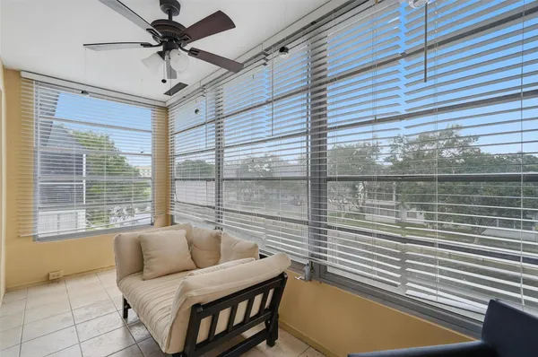a bedroom with furniture and a large window