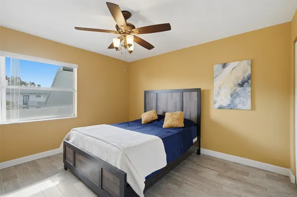 a bedroom with a bed and a chandelier